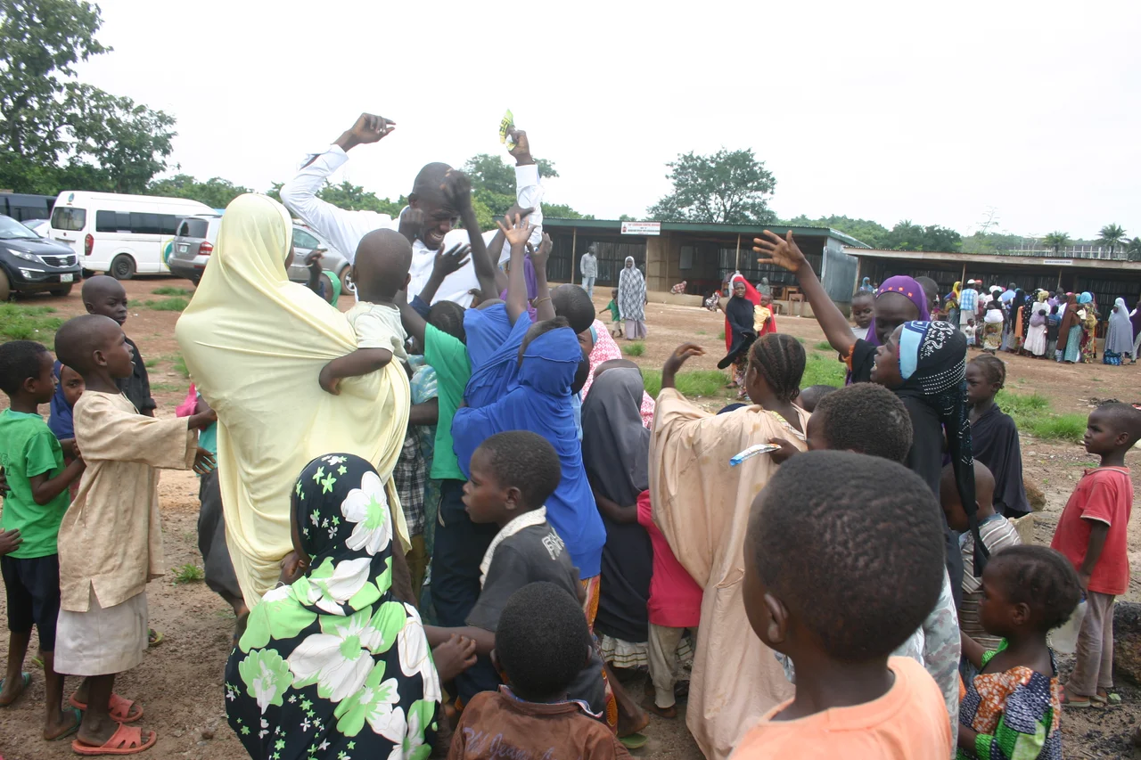 We went to Bama and Gwoza Internally Displaced People (IDP) Camp at Durumi, Area 1, Abuja to give them drugs, medical check-ups and counseling with 5 Medical Doctors. 
A short story on how the journey went;
As we got there, we started calling the women and children, as their men has gone out for work. At first, they refused to come for reason best known to them.
After some time, some women began to come but the turn up was still low. At that moment, we were yet to fathom why they were dragging foot to come and collect free drugs. Until I met a little boy, his name is Ali, he was like the leader of the little lads. It was him that gave me the idea that we should get them food instead of drugs.
That was how the idea of food for drugs came into our mind. Collect your drugs before we give you food, simple. Before we could know it, the little Ali has already mobilized almost all the children in the camp and the women simply because we provided food as incentives until we were overwhelmed.

It even got to a point where they drag the food from our hands due to extreme starvation.